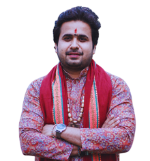Man with folded arms wearing a patterned kurta and red scarf, with a beaded necklace and a watch on his wrist.