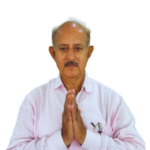 Elderly man with pink shirt holds palms together in greeting (Namaste) against a black background.